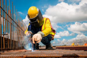 Man welding metal in construction site