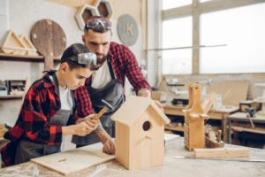 Father and son building a bird house