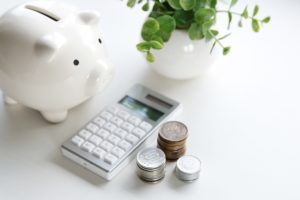 piggy bank, coins, and calculator