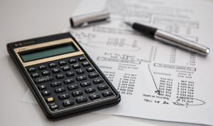 calculator a pen and a sheet of paper