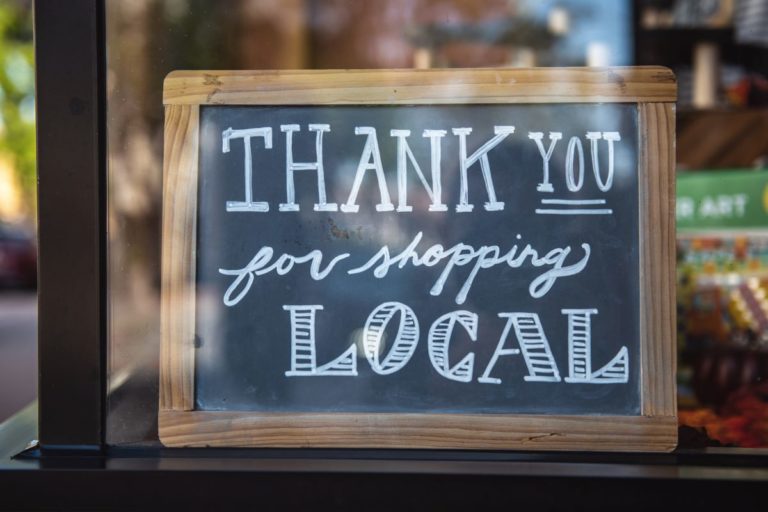 sign that reads "thank you for shopping local"