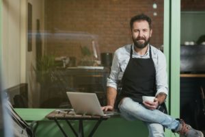 man sitting outside cafe