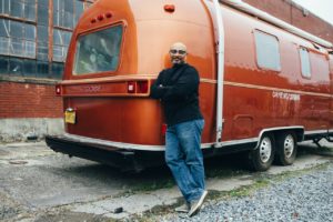 man standing next to an RV