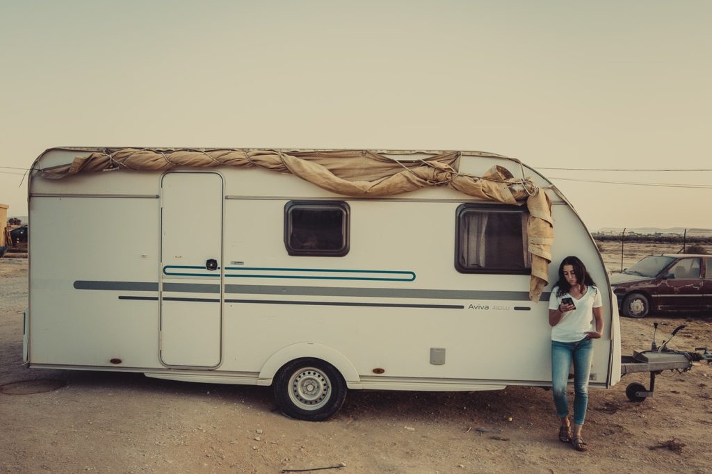 woman standing next to a camper