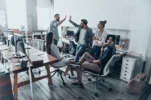 employees getting a high-five from each other