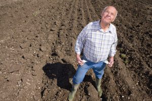 farmer on plowed soil