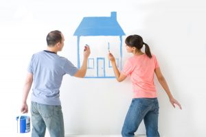 couple drawing a house on the wall