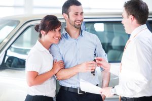 couple talking with a car sales agent
