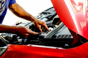 man fixing a car engine